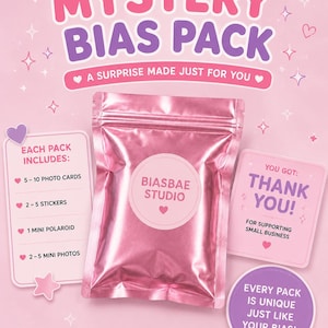 May include: A pink Mystery Bias Pack featuring a metallic pouch labeled Biasbae Studio, surrounded by informational cards listing contents like photo cards, stickers, and a mini polaroid, with text including A Surprise Made Just For You and Thank You.