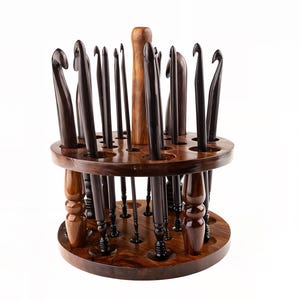 May include: A wooden crochet hook holder with multiple dark brown crochet hooks. The holder is made of dark wood and has a two-tiered design with holes to hold the hooks. The hooks vary in size and shape.