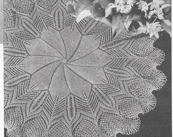 May include: An off-white, crocheted doily with an elaborate starburst pattern at its centre. The lace design includes a scalloped edge and openwork details. This handmade doily would add a vintage feel to any home. The measurements are in centimetres.