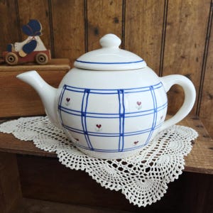May include: A set of three ceramic mugs with a speckled, matte finish. The mugs are in shades of cream, light gray, and dark gray. Each mug has a simple, minimalist design, perfect for coffee or tea.
