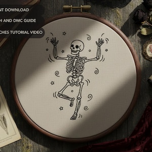 May include: An embroidery hoop with a dancing skeleton design. The black and white illustration features a skeleton with arms raised, surrounded by stars and swirls. Text at the top reads "PDF INSTANT DOWNLOAD", "FULL STITCH AND DMC GUIDE", and "BASIC STITCHES TUTORIAL VIDEO".