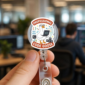 May include: A circular badge reel featuring a cartoon goose wearing glasses and holding a laptop. The text reads PROFESSIONAL CODE GOOSE. The design includes binary code, circuit board patterns, and keyboard keys labeled W, A, S, and D.