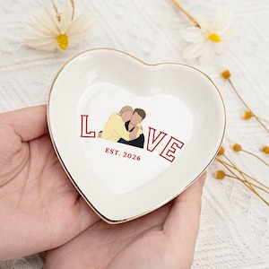 May include: A set of three ceramic mugs with a speckled, matte finish. The mugs are in shades of cream, light grey, and dark grey. Each mug has a simple, minimalist design, ideal for coffee or tea.