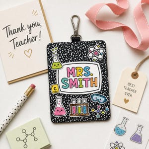 May include: A black and white composition notebook-style teacher ID badge with the name "MRS. SMITH" in colorful letters. The badge is decorated with science-themed stickers and a metal clip. A "Thank you, Teacher!" card and a "Best Teacher Ever" tag are also visible.