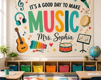 May include: A cream-colored fabric wall hanging featuring the text IT'S A GOOD DAY TO MAKE MUSIC and Mrs. Sophia. The design includes colorful illustrations of a guitar, headphones, a microphone, a tambourine, a xylophone, a drum, and music notes.