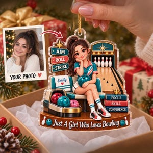 May include: A custom acrylic ornament featuring a cartoon bowling player sitting on a bench with a bowling ball. The design includes text reading AIM, ROLL, STRIKE, Emily, FOCUS, SKILL, CONFIDENCE, and Just A Girl Who Loves Bowling, with a photo insert.