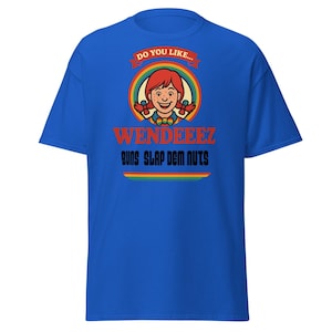 May include: A royal blue t-shirt featuring a graphic of a cartoon girl with red hair and the text "WENDEEEZ BUNS SLAP DEM NUTS". The design includes a rainbow and the words "DO YOU LIKE..." above the girl's head.
