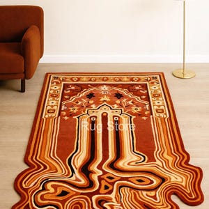May include: A rectangular rug with a unique design, featuring a central pattern with floral motifs and the text "Rug Store". The rug's color palette includes shades of brown, orange, and cream, with a flowing, melted-like border.