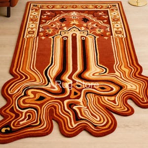 May include: A rectangular rug with a unique, flowing design in shades of red, orange, and cream. The rug features a central, ornate pattern with a border and a melting, abstract design extending from the bottom. The rug's dimensions are not visible.