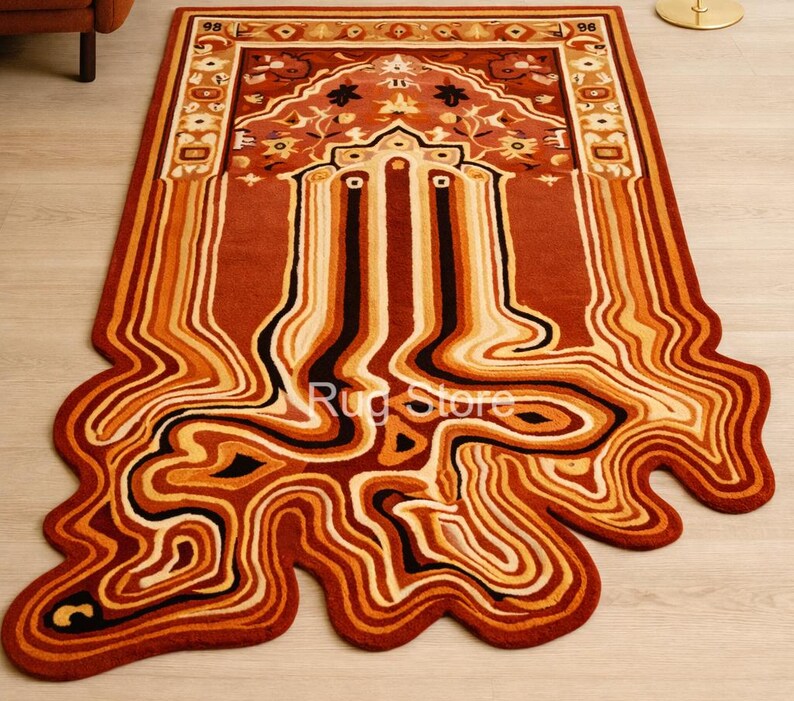 May include: A rectangular rug with a unique, flowing design in shades of red, orange, and cream. The rug features a central, ornate pattern with a border and a melting, abstract design extending from the bottom. The rug's dimensions are not visible.