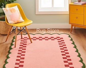 Tapete de lã tufado à mão: rosa blush com borda xadrez vermelha e borda ondulada verde-oliva.