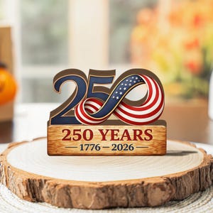 May include: A wooden commemorative display featuring the number "250" with an American flag design. The base reads "250 YEARS 1776-2026" in a rustic font. The display is set on a wooden slice, celebrating a significant anniversary.