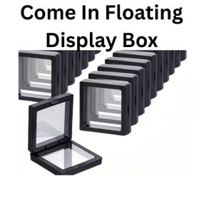May include: Black floating display boxes with clear windows. The boxes are arranged in a row, with one open to display the interior. The text "Come In Floating Display Box" is at the top.