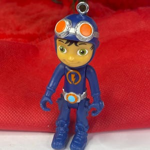 May include: A white ceramic mug with a black handle and the text "But First, Coffee" in a black, bold font. The mug is on a white surface. The mug is approximately 4 inches tall.