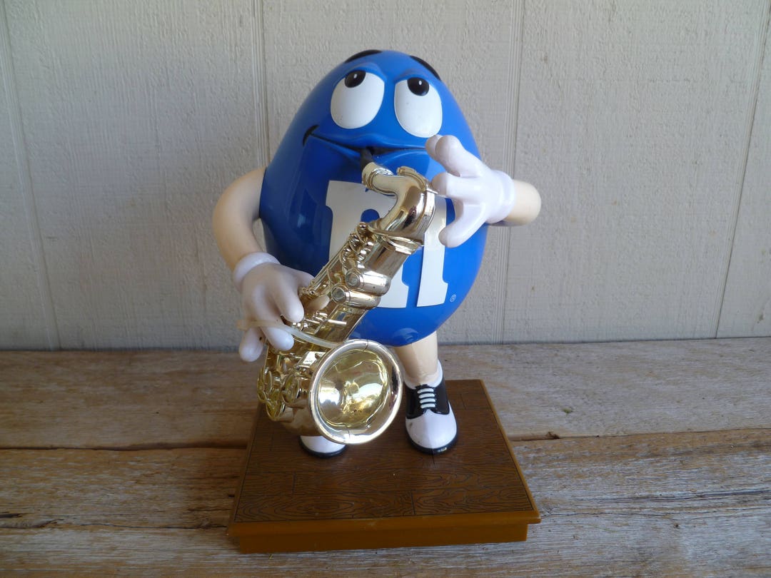 M & M Blue Playing Saxophone Dispenser Advertising 6.5