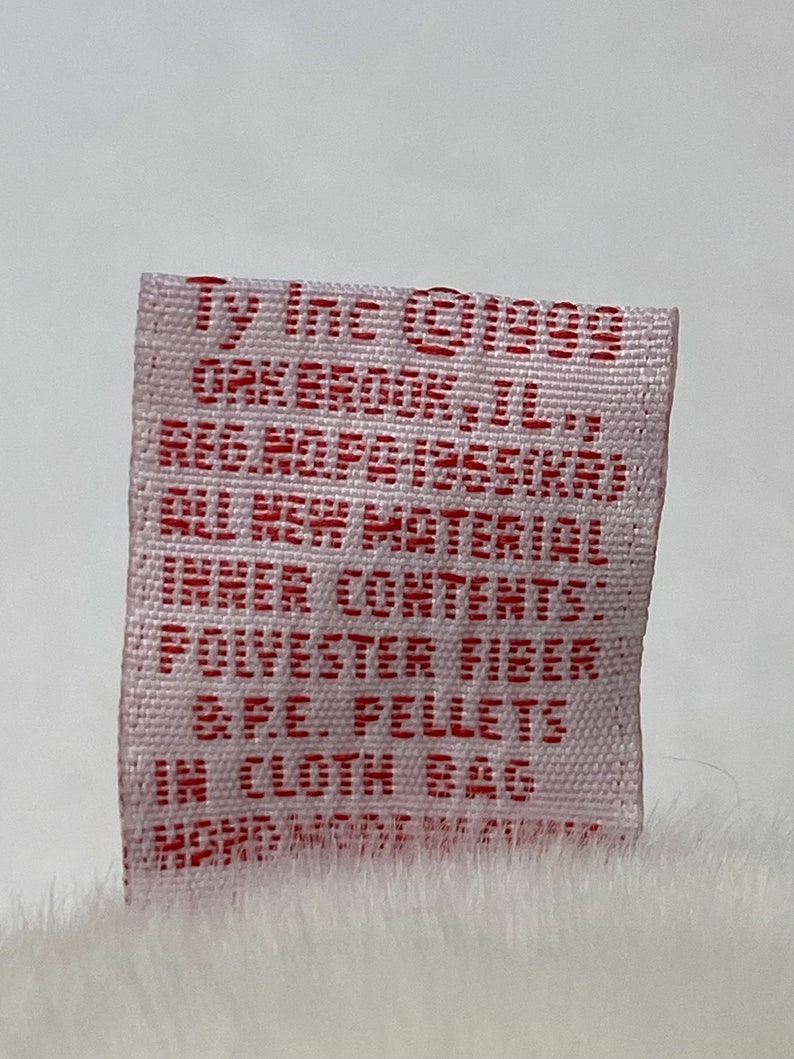 May include: A white fabric tag with red text that reads "Ty Inc &copy;1999 Ork Brook, IL. Reg. No. PA-1955(KAI) All New Material Inner Contents: Polyester Fiber BPE Pellets In Cloth Bag"