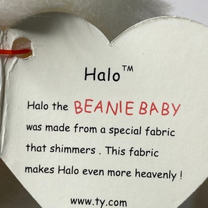 May include: White heart-shaped tag with the text "Halo&trade; Halo the BEANIE BABY was made from a special fabric that shimmers. This fabric makes Halo even more heavenly! www.ty.com"
