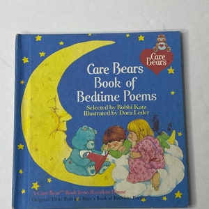 May include: A blue book with a yellow crescent moon and stars. The book cover features a Care Bear character reading a book to two children. The title is "Care Bears Book of Bedtime Poems".