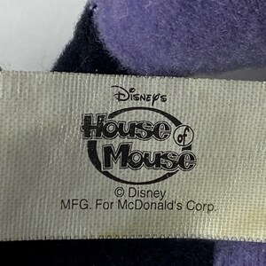 May include: A white tag with black text that reads "Disney's House of Mouse &copy; Disney MFG. For McDonald's Corp."