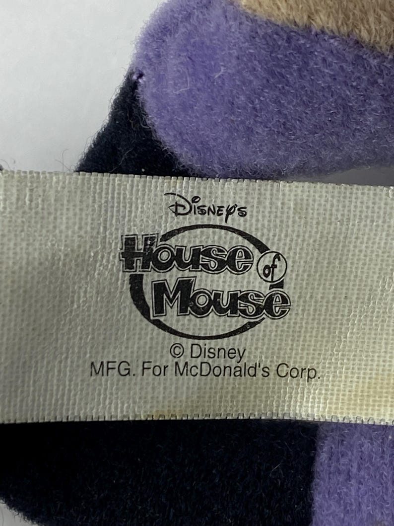 May include: A white tag with black text that reads "Disney's House of Mouse &copy; Disney MFG. For McDonald's Corp."