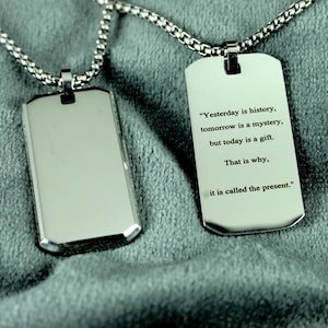 May include: Two silver dog tag pendants on a chain. One tag is blank, the other has the quote: "Yesterday is history, tomorrow is a mystery, but today is a gift. That is why, it is called the present."