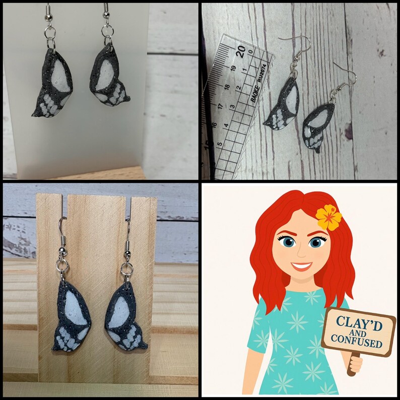 May include: Butterfly wing earrings with a black and white speckled design. The earrings are displayed on a wooden stand. The image also includes a ruler with metric measurements and a cartoon with the text "CLAY'D AND CONFUSED".