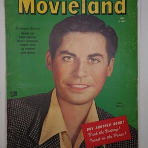 Puede incluir: Una portada de revista vintage "Movieland" con un retrato de John Hodiak sobre un fondo verde. El título de la revista está en letras amarillas grandes. La portada incluye texto como "Exclusive Stories" y una pancarta roja que dice "Buy Another Bond!"