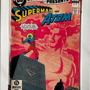 May include: A vintage DC Comics Presents comic book featuring Superman and The Atom. The cover art showcases Superman's emblem, a tombstone that reads "Here Lies Superman," and a dynamic illustration of The Atom. The comic is in a protective sleeve.