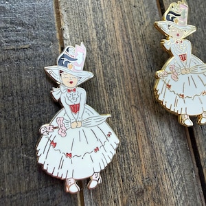 Mary Poppins Jolly Holiday with penguin enamel pin in gold and silver