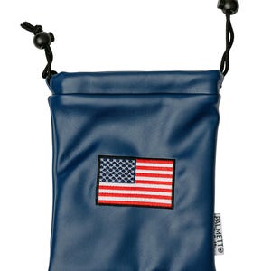 May include: A navy blue drawstring pouch with a stitched American flag patch. The pouch has a black drawstring closure and the brand name "PALMETTO" printed on the side. The pouch is made of a smooth, possibly leather-like material.