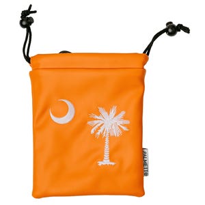 May include: An orange drawstring bag with a white crescent moon and palm tree design. The bag has black drawstrings and a small white tag that reads "PALMETTO".
