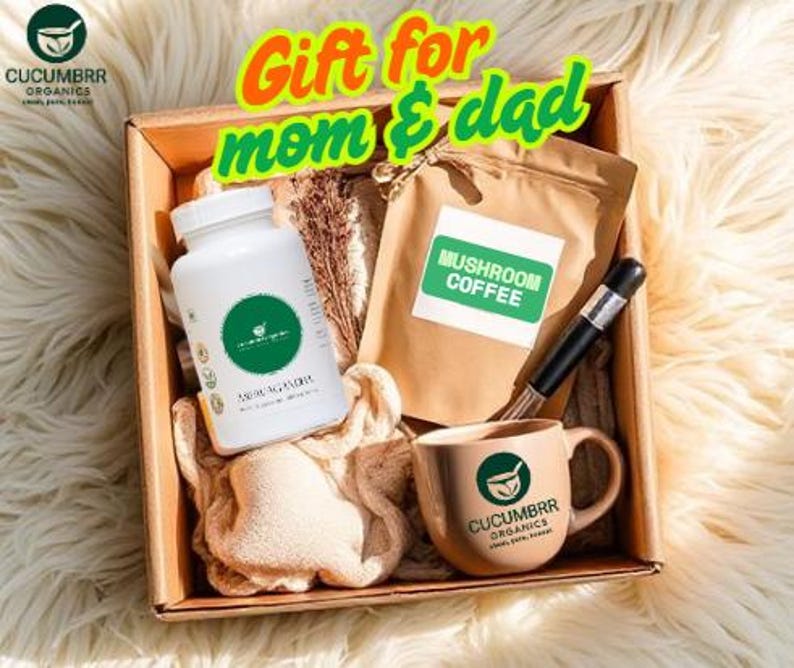 May include: A gift box containing a white bottle, a bag of mushroom coffee, a mug, and a whisk. The mug and bottle have a green logo. The text "Gift for mom & dad" is displayed in the top center of the image.