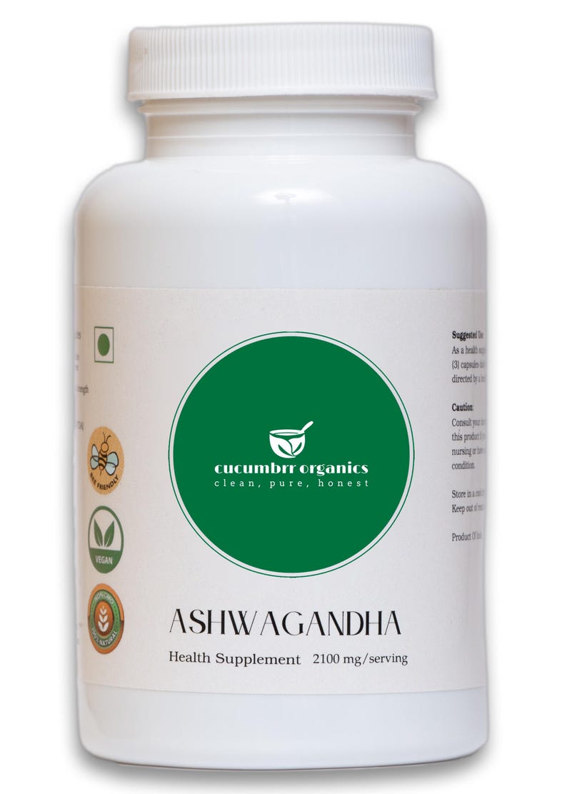 May include: White plastic bottle of Ashwagandha health supplement. The label features a green circle with the text "cucumbrr organics clean, pure, honest" and the word "ASHWAGANDHA". The bottle contains 2100 mg per serving.