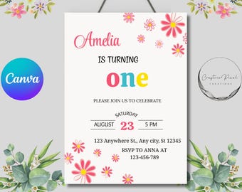 以下が含まれることがあります： ピンク色の筆記体で「Amelia」と書かれた誕生日招待状で、「IS TURNING ONE」と発表しています。招待状には日付、時間、場所、花のアクセントが含まれています。 Canvaのロゴは左上にあります。