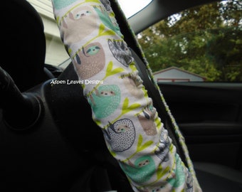 Sloth steering wheel cover. Fully lined green and gray playing sloths.