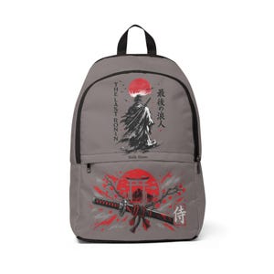May include: A grey backpack featuring a graphic of a ronin standing under a red sun with the text "THE LAST RONIN" and "Walk Alone." The lower section displays a katana, a torii gate, and red cherry blossom accents with Japanese characters.