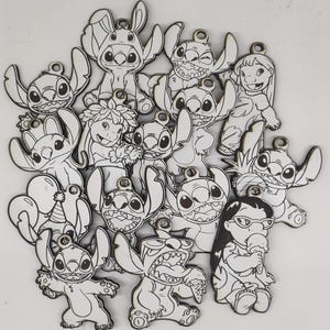 May include: A collection of laser-cut wooden Stitch character charms. Each charm features a black outline design of Stitch in various poses, along with other characters. The charms have small holes for attaching to keychains or jewelry.