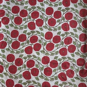 May include: A white fabric featuring a repeating pattern of dark red circular flowers with textured centers. The flowers are connected by winding brown stems adorned with small, light green leaves arranged in a continuous, flowing vine design.