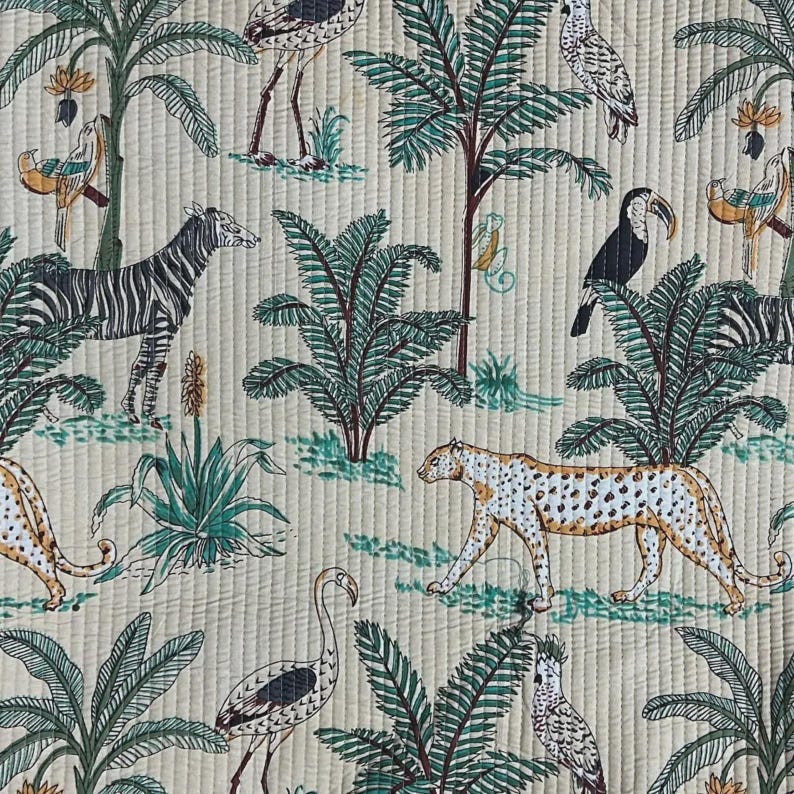 May include: A quilted fabric featuring a repeating jungle pattern on a light beige background. The design includes black and white zebras, spotted leopards, various tropical birds, and green palm trees with small yellow flowers.