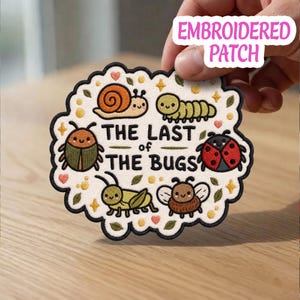 May include: Embroidered patch featuring various cartoon bugs, including a snail, caterpillar, beetle, ladybug, grasshopper, and bee. The patch has the text "THE LAST of THE BUGS" and is surrounded by a scalloped edge.