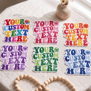 May include: Six custom stickers featuring wavy, retro-style typography that reads YOUR CUSTOM TEXT HERE. Each sticker displays a different color palette, including rainbow, pink, orange, purple, green, and blue, with small disco ball and star accents.