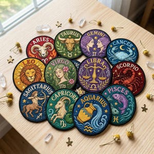 May include: A collection of twelve circular embroidered patches featuring the zodiac signs Aries, Taurus, Gemini, Cancer, Leo, Virgo, Libra, Scorpio, Sagittarius, Capricorn, Aquarius, and Pisces, each with distinct colors and detailed illustrations.