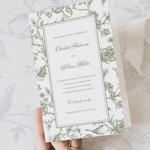 Peut inclure: Une carte d'invitation de mariage rectangulaire avec un fond blanc et une bordure illustrée de motifs botaniques et d'oiseaux vert sauge. Le texte indique : Welcome to the wedding of Charlotte Anderson and William Miller, Saturday, the twenty-fourth of August, two thousand twenty-five, at five o'clock in the evening, St. John's Cathedral, Wellington, Our happily ever after, With hearts full of love.