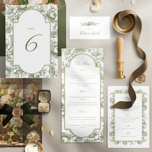 Peut inclure: Ensemble de papeterie de mariage élégante avec un motif floral vert et blanc. Comprend un numéro de table, un menu, une carte de place et une invitation. Une boîte à bagues et un sceau de cire sont également présents.