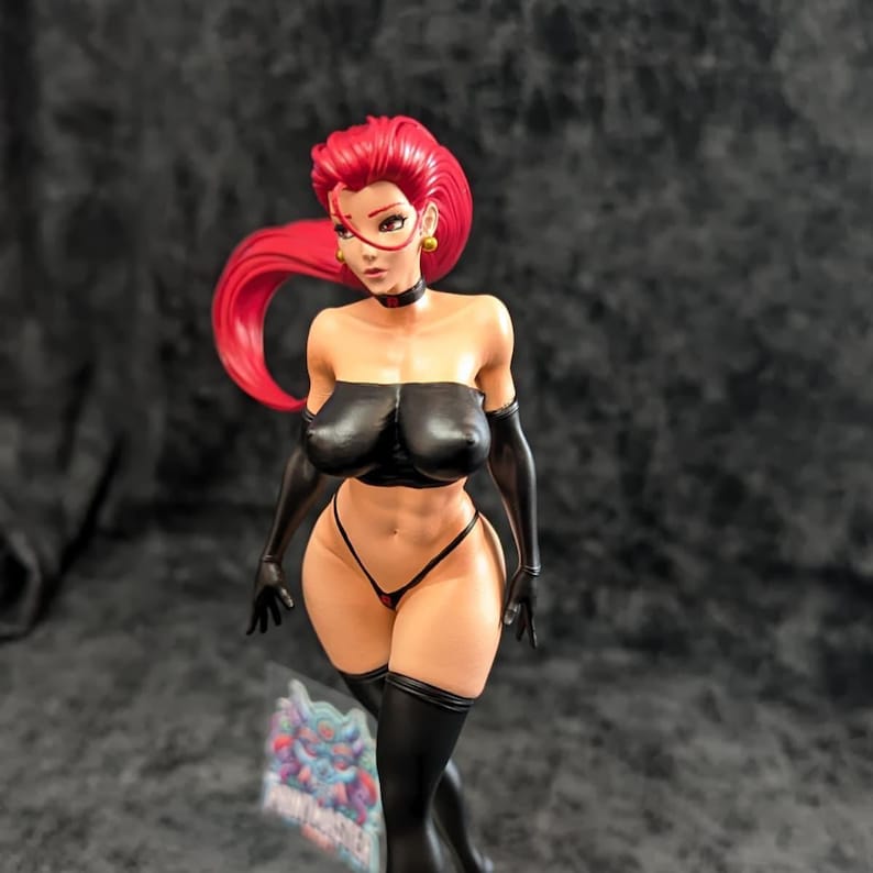 May include: A figurine of a woman with red hair, wearing a black strapless top, matching gloves, and thigh-high boots. The figure has a choker and gold earrings. The figurine is standing in front of a dark background.