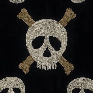 May include: Black fabric with an embroidered skull and crossbones design. The skull is white with a detailed texture, and the crossbones are tan. Several skull and crossbones motifs are visible across the fabric.