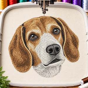 May include: A detailed machine embroidery design of a beagle dog face centred in a plastic embroidery hoop. The dog features brown, tan, and white fur with black accents around the ears and a black nose, stitched onto a light beige fabric.