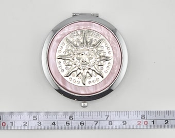 Compacto redondo de estilo vintage con temática solar