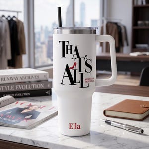 May include: White tumbler with a handle and a black straw. The tumbler has the text "That's All" with a red high heel shoe graphic and the name "Miranda Priestly". The name "Ella" is printed at the bottom.