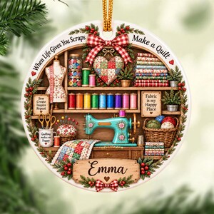 May include: A round ceramic ornament featuring a sewing room scene with a teal sewing machine, colorful thread spools, fabric stacks, and a mannequin. The text reads When Life Gives You Scraps Make a Quilt, Fabric is my Happy Place, and Emma.